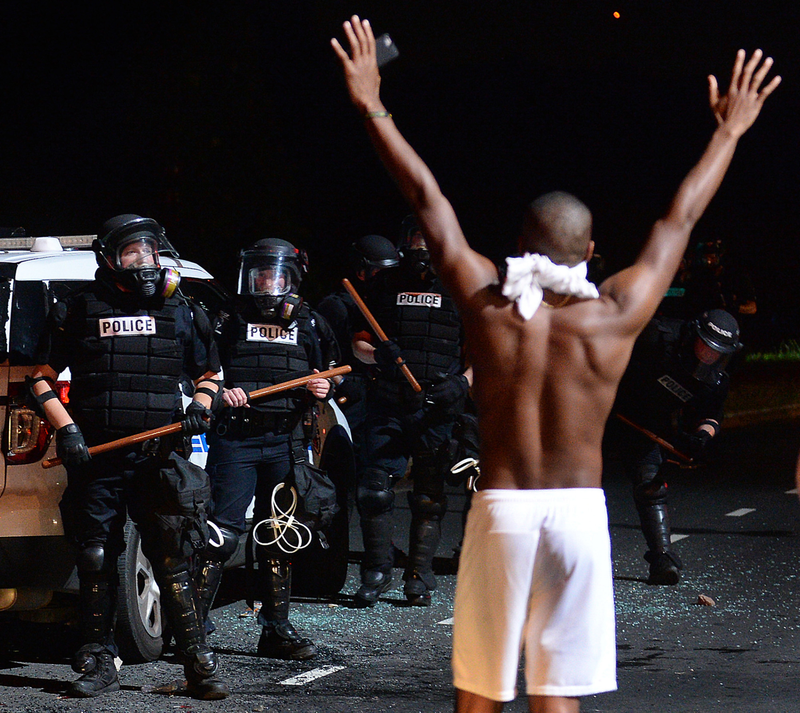 A protester approaches Charlotte-Mecklenburg police officers with his arms up on Old Concord Road in Charlotte, N.C., on Sept. 20, 2016. Jeff Siner/Charlotte Observer/TNS via Getty Images